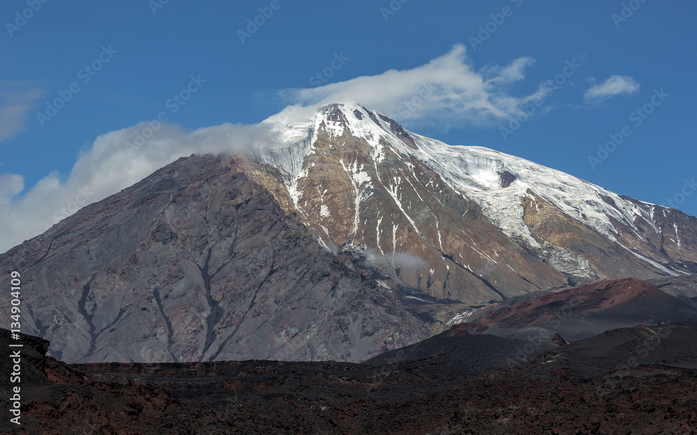 The active lava flow from a new crater on the slopes of volcanoes Tolbachik, on background volcano Plosky Tolbachik - Kamchatka, Russia