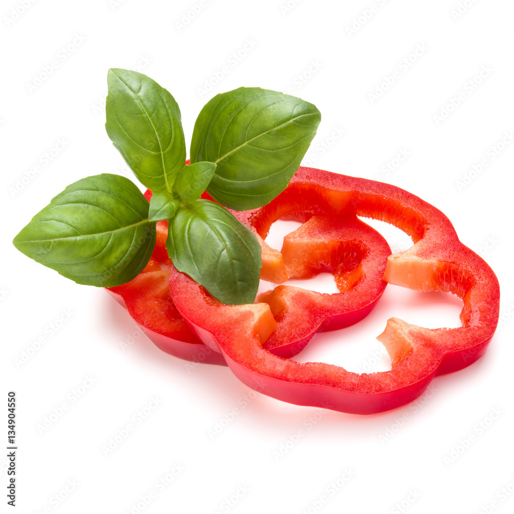 Red sweet bell pepper slices and basil leaves isolated on white Red sweet bell pepper slices and basil leaves isolated on white