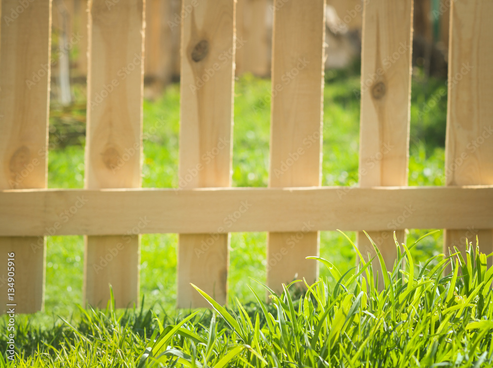 green grass over wood fence background green grass over wood fence background