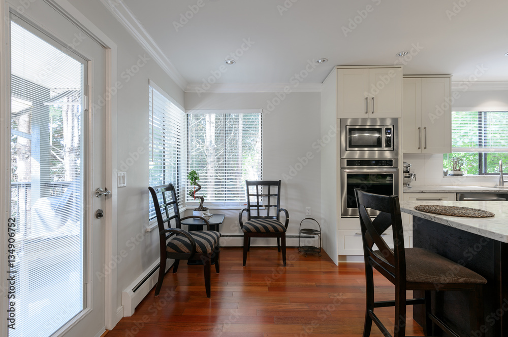 Modern kitchen and dining room interior with stainless steel appliances in a luxury house. Modern kitchen and dining room interior with stainless steel appliances in a luxury house.