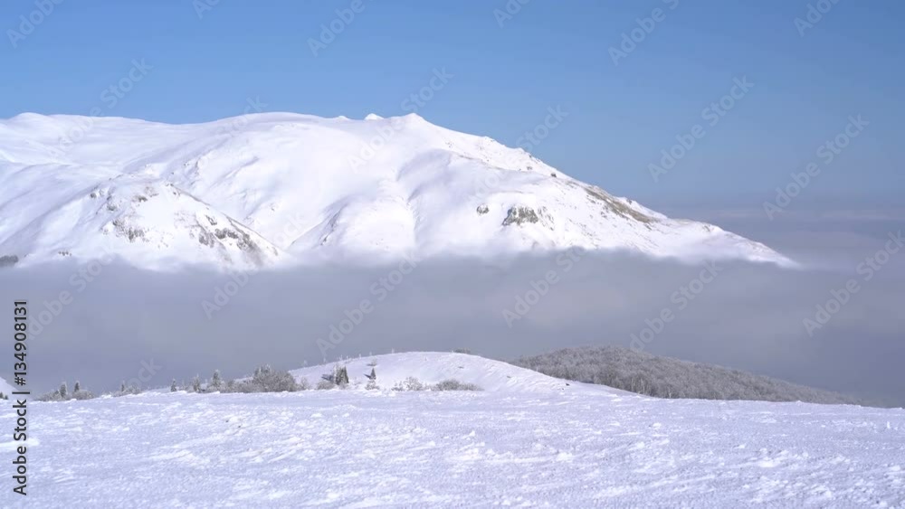panoramic view of the snow-capped mountains above the clouds panoramic view of the snow-capped mountains above the clouds