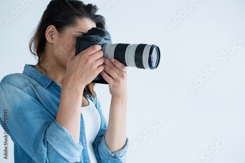 Wall Mural Female photographer with digital camera
