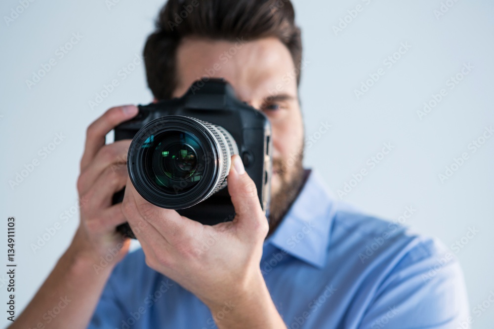 Male photographer with digital camera in studio Male photographer with digital camera in studio