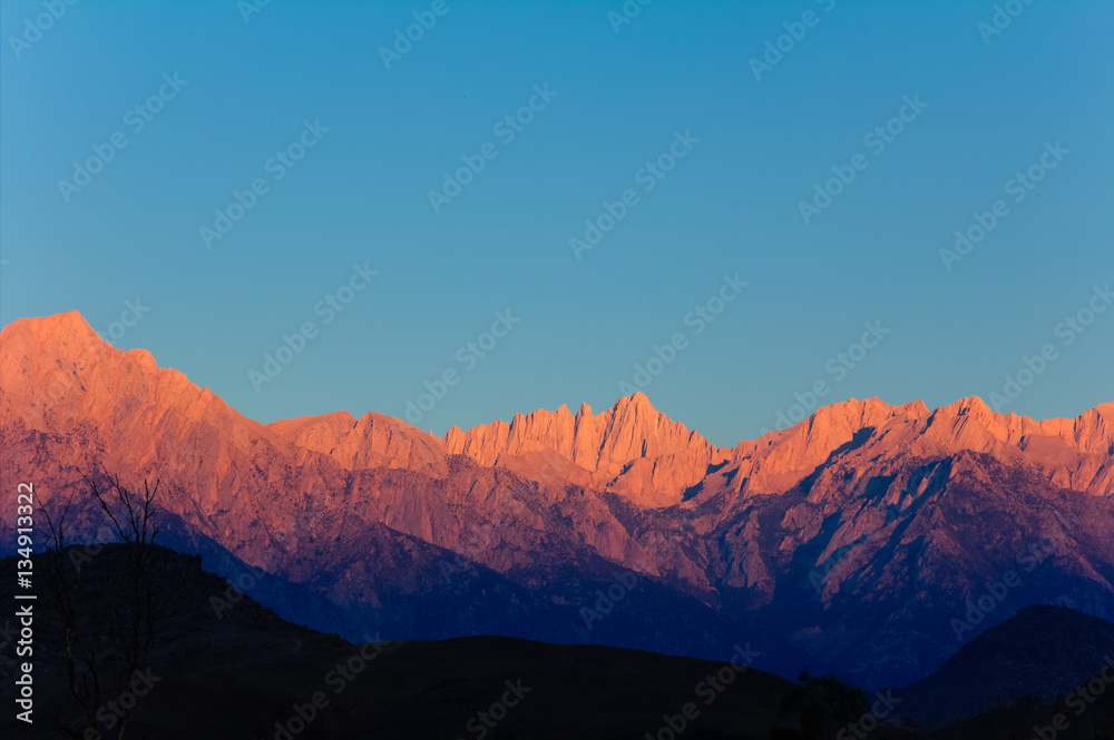 Early morning sunlight on the peaks of the Mount Whitney range above Lone Pine, California