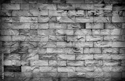 Dark sandstone wall texture background.Detail of sand stone wall
