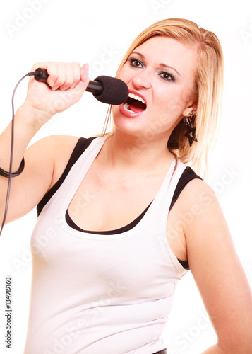 Blonde woman singing to microphone