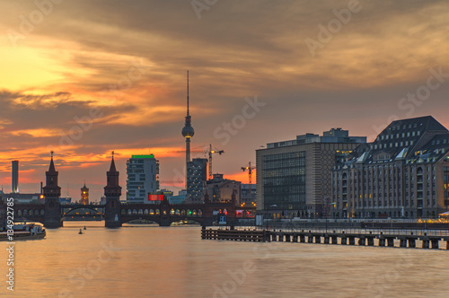 Fire in the sky over Berlin with the famous television tower and the river Spree