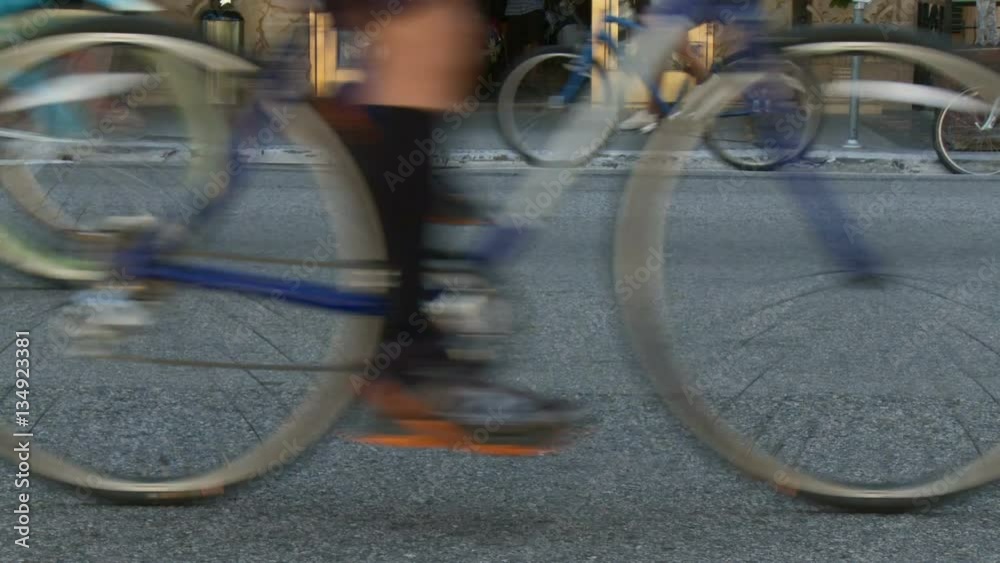 Bicycle Wheels Drive By. Bicycle wheels pass by on the asphalt at Bicycle Wheels Drive By. Bicycle wheels pass by on the asphalt at