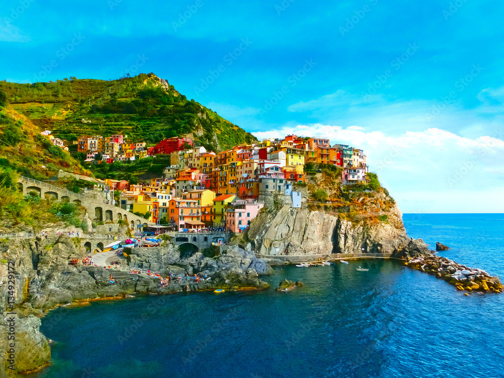Colorful traditional houses on a rock over Mediterranean sea, Manarola, Cinque Terre, Italy
