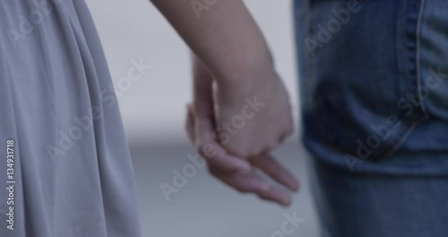 A couple is holding hands and lets go
