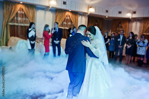 First wedding dance of newlyweds on heavy smoke.