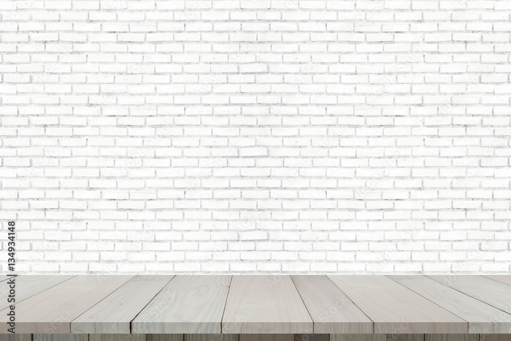 Wooden floor with old brick wall for background.