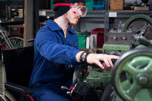 Young Mechanic / Apprentice In Wheelchair Working On Turning Lathe