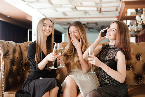 Cheerful girls clinking glasses of champagne at the party