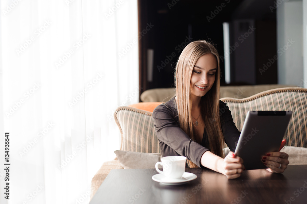 Beautiful pregnant woman using digital tablet at table in cafe Beautiful pregnant woman using digital tablet at table in cafe