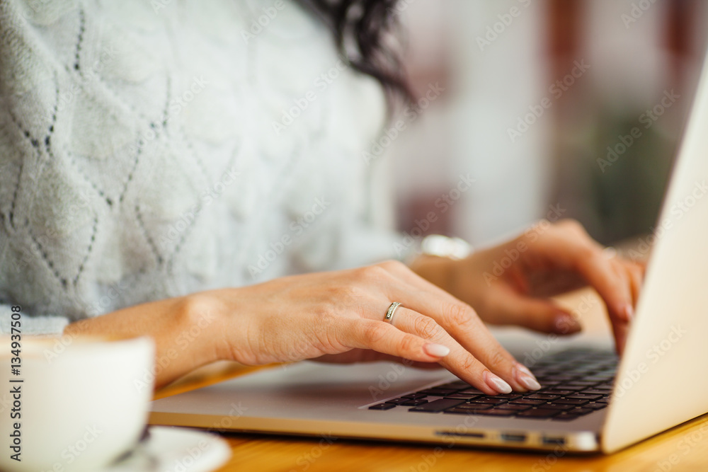 female hands typing on a laptop female hands typing on a laptop
