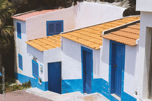 common and simple design of white and blue house in Madeira island, Portugal