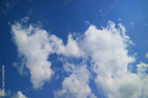 The blue sky and beautiful white clouds.