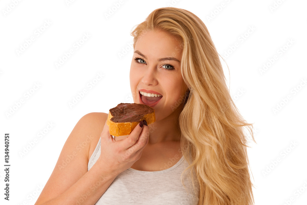 Young blond woman eating breakfast bread and nougat spread isola Young blond woman eating breakfast bread and nougat spread isola