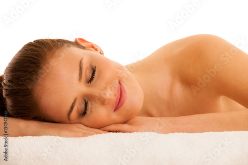 woman rests on white towel - conceptual photo for skin care and