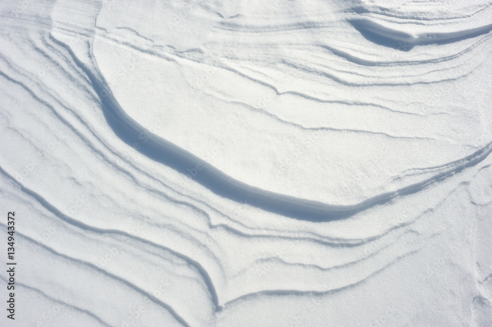 Coarse texture of the snow, accented by a sliding sun light Coarse texture of the snow, accented by a sliding sun light