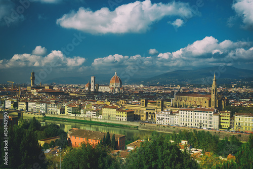 View of the beautiful medieval italian city and culture capital - Florence with cathedrals and bridges over river and blue cloudy sky. Travel outdoor sightseeing historical background.