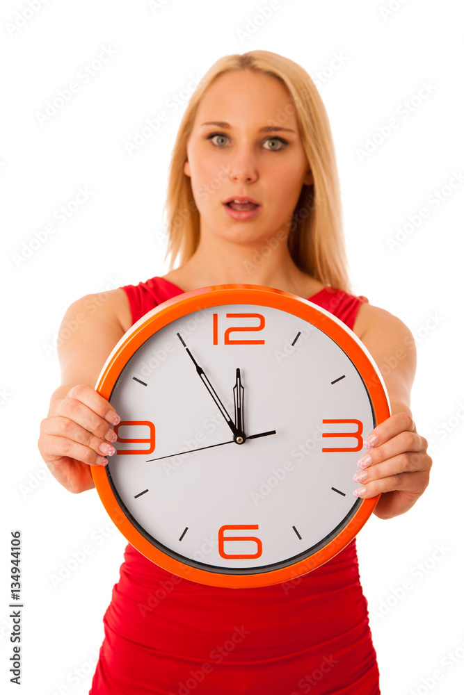 Blonde business woman in red shirt holds clock as sign for time Blonde business woman in red shirt holds clock as sign for time