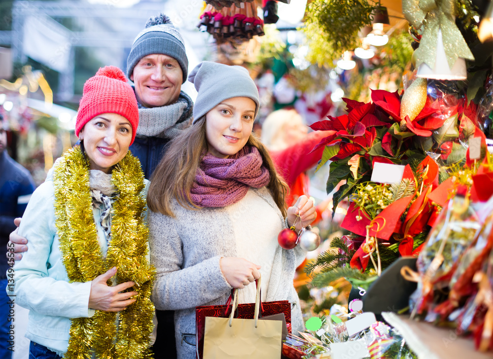 positive parents with teenage girl at counter with Poinsettia an