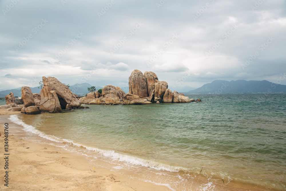 Beautiful landscape with view of ocean, perfect beach, big stones, trees, azure water. Background image. Concept travel Beautiful landscape with view of ocean, perfect beach, big stones, trees, azure water. Background image. Concept travel