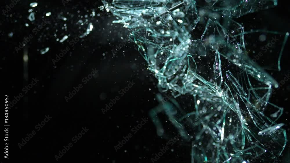 Slow Motion Glass Shattering From Right-To-Left Over Black Background in 4k