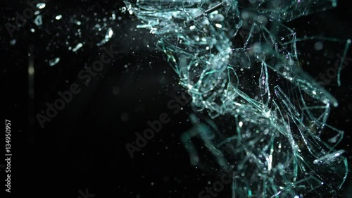 Slow Motion Glass Shattering From Right-To-Left Over Black Background in 4k