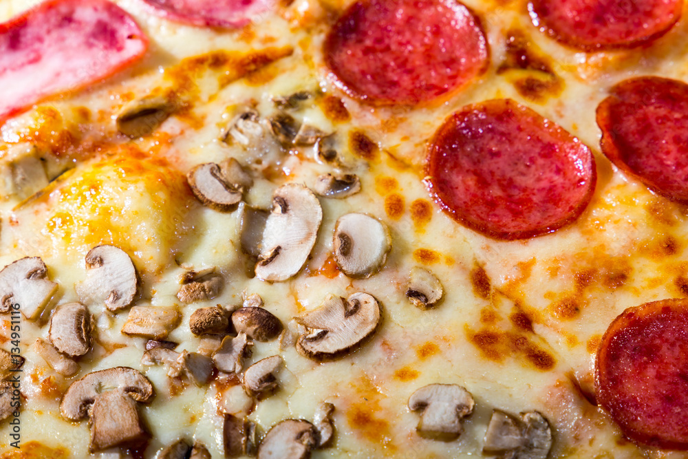 Four taste pizza with pepperoni cheese mushrooms and becon useful for background Four taste pizza with pepperoni cheese mushrooms and becon useful for background