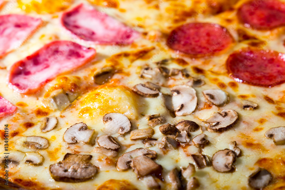 Four taste pizza with pepperoni cheese mushrooms and becon useful for background Four taste pizza with pepperoni cheese mushrooms and becon useful for background