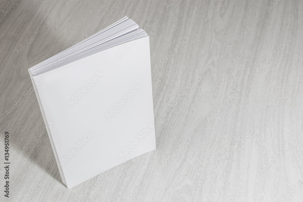 Fototapeta premium Real 3D paperback white books on a wood background