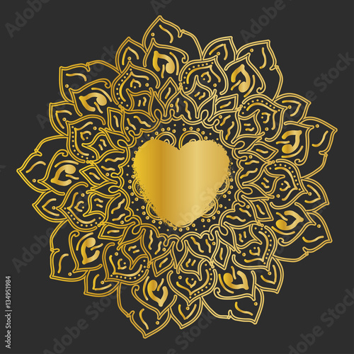 Mandala. Gold round ornament pattern on black background. photo