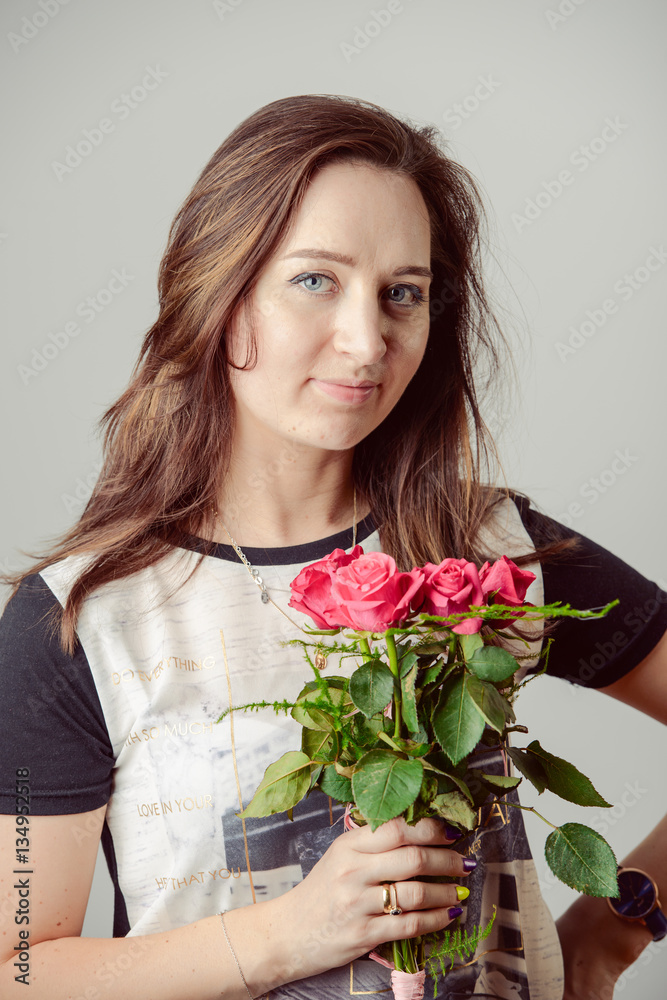 portrait of young charming girl with a bouquet of roses portrait of young charming girl with a bouquet of roses