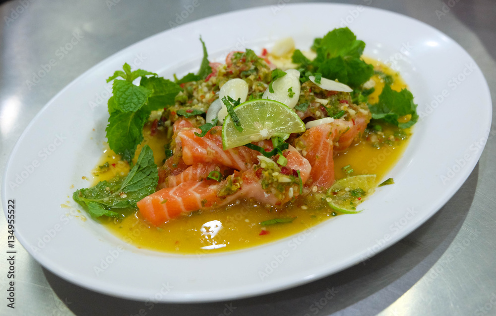 Salmon spicy salad in the white plate, Thailand Salmon spicy salad in the white plate, Thailand
