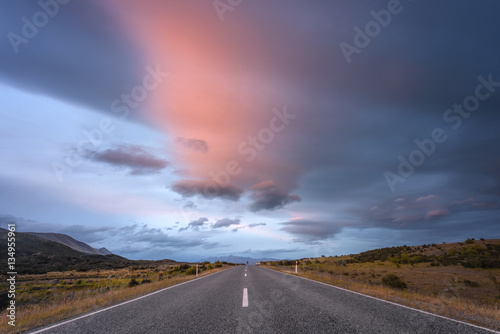 Driving on an empty asphalt road at sunset © ID_Anuphon