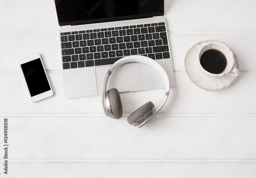 Headphones, laptop computer, mobile phone and cup of coffee Headphones, laptop computer, mobile phone and cup of coffee