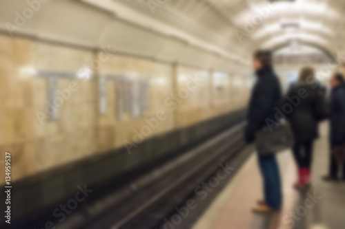 Blurred image of people walking around Metro station in Moscow.