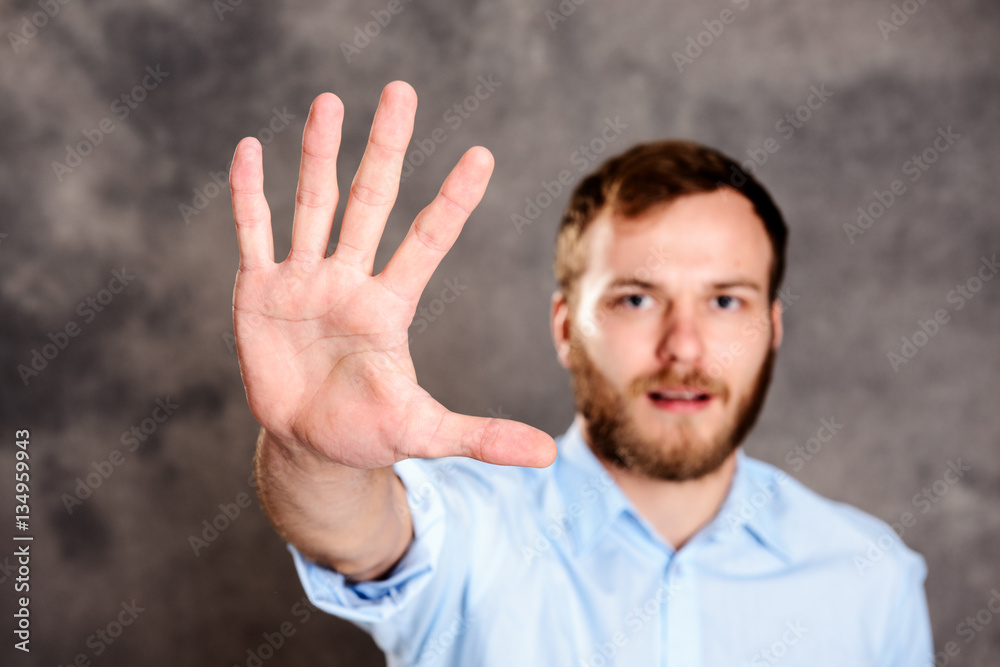 young man looking angry and showing open hand young man looking angry and showing open hand