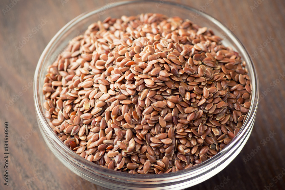 flax seeds in bowl on table background flax seeds in bowl on table background