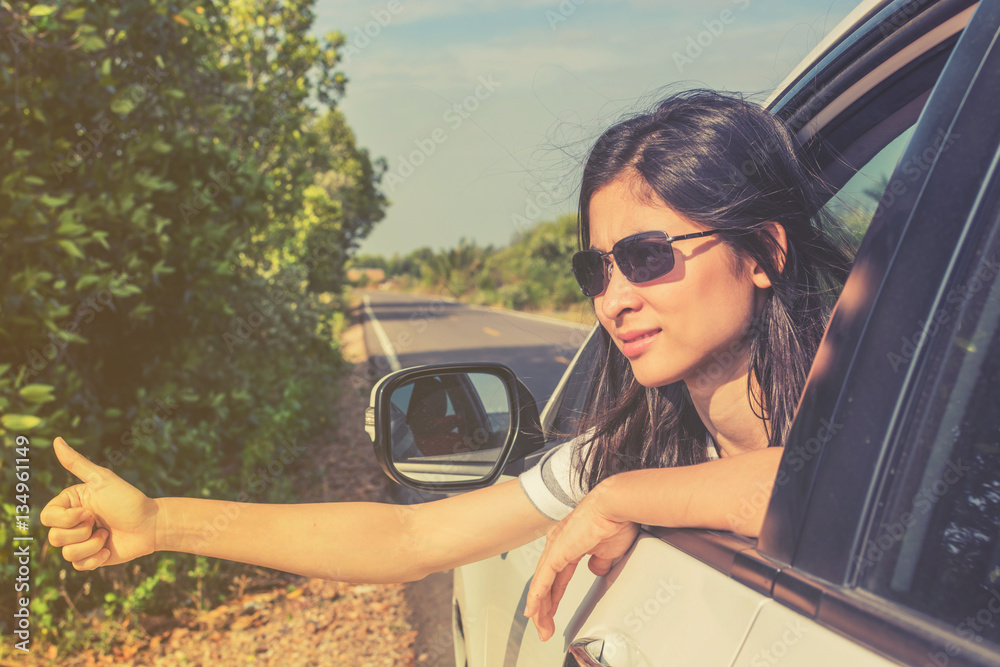 Happy young woman travel vacation leaning out car window on blue Happy young woman travel vacation leaning out car window on blue