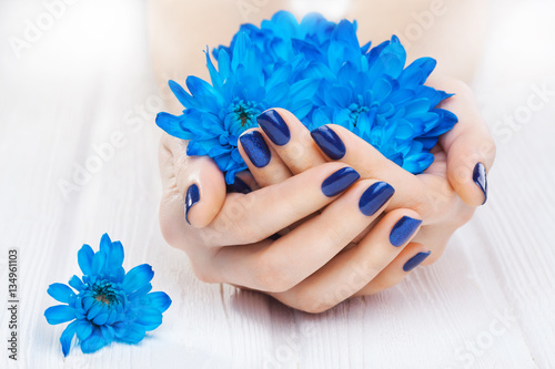 blue manicure with chrysanthemum flowers. spa
