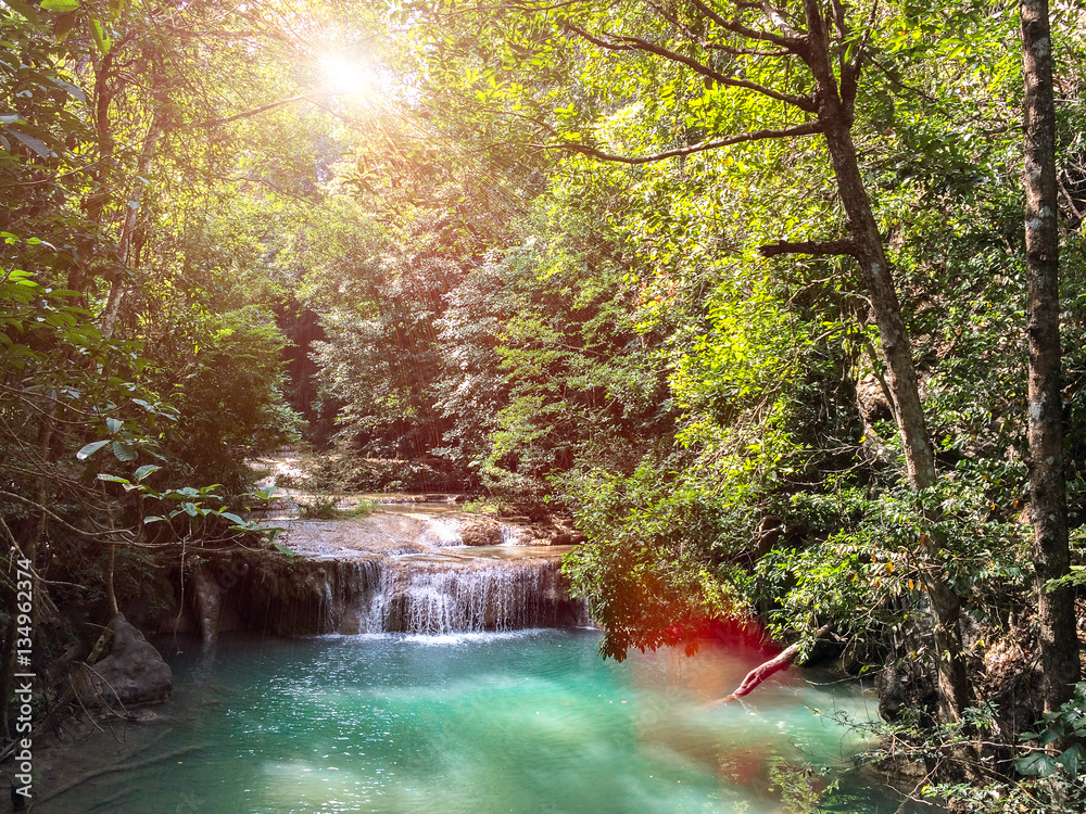 Fototapeta premium Part of Ngao Waterfall in Ranong, Thailand. Waterfall Crashing Big Stone on The Clear Natural Water