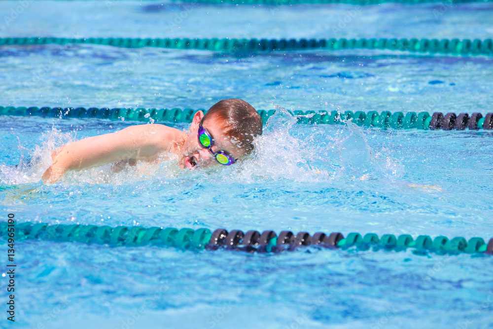 Boy in a freestyle swim race