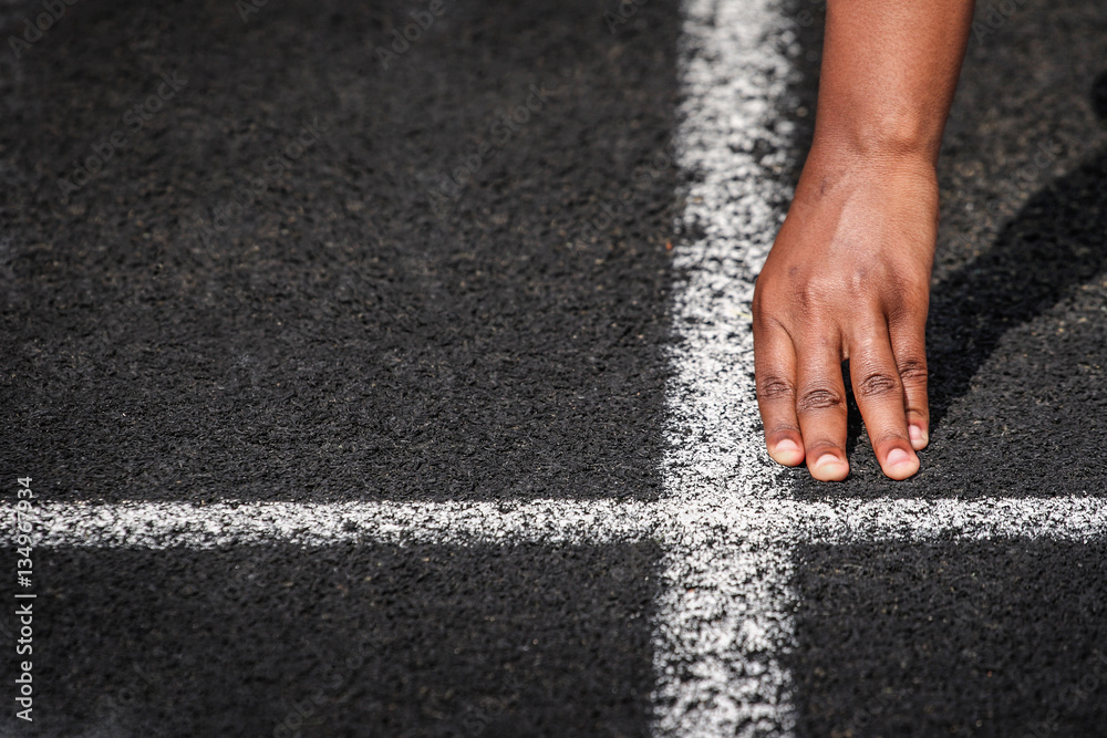 Hand at the starting line in a track and field race