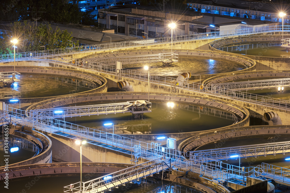 Modern urban wastewater treatment plant.Water purification is the process of removing undesirable chemicals, suspended solids and gases from contaminated water. Water cleaning facility outdoors.