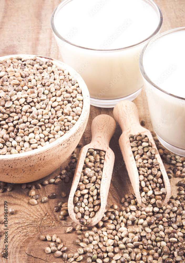 Hemp milk, seeds on wooden background . Close Up . Hemp milk, seeds on wooden background . Close Up .