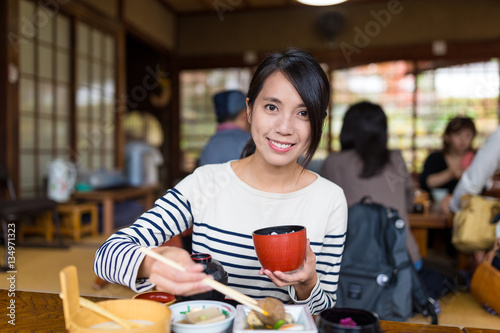 Woman enjoy her lunch in Japanese restaurant